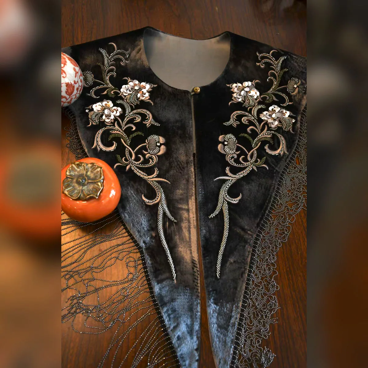 Detail view of an espresso velvet beaded fringe collar with floral beadwork and fringe